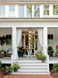front-porch-comely-home-exterior-decoration-with-black-basket-and-square-flowers-pots-combine-with-white-pillars-and-stair-also-gray-floor-complete-with-wood-top-rectangular-table-and-white-curtains-718x958